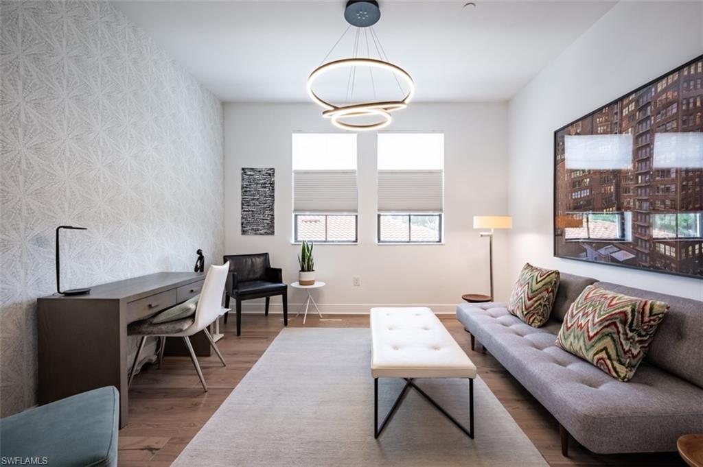 16360 Viansa Way, Unit 8201 Naples, FL 34110 - Photo 21 of 35 a living room with furniture and a large mirror next to a window