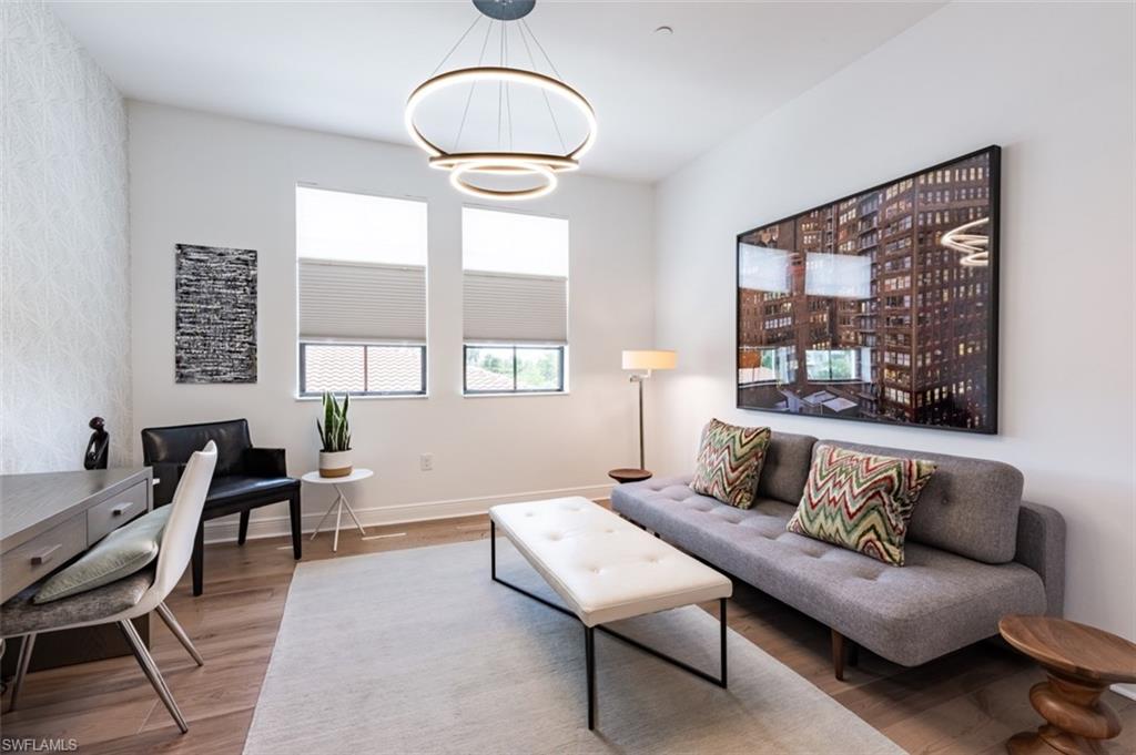 16360 Viansa Way, Unit 8201 Naples, FL 34110 - Photo 22 of 35 a living room with furniture and a large window