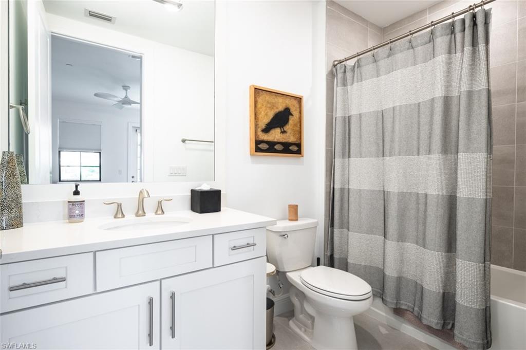 16360 Viansa Way, Unit 8201 Naples, FL 34110 - Photo 24 of 35 a bathroom with a toilet sink and mirror