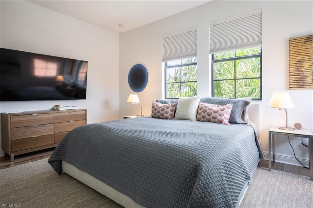 16360 Viansa Way, Unit 8201 Naples, FL 34110 - Photo 26 of 35 a bedroom with a bed and a flat screen tv