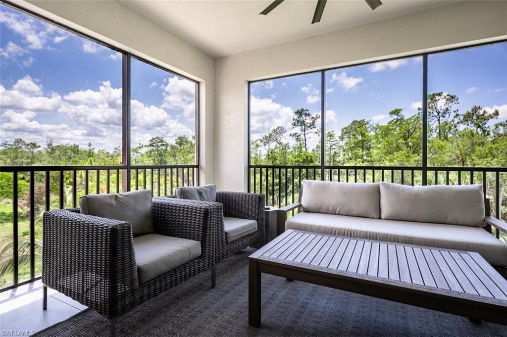 16360 Viansa Way, Unit 8201 Naples, FL 34110 - Photo 29 of 35 a balcony with furniture and a floor to ceiling window