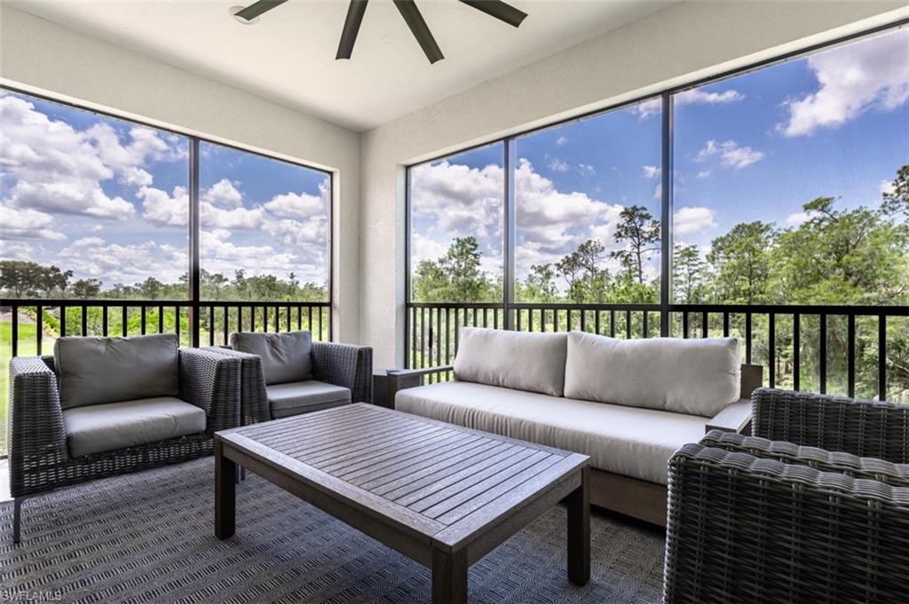 16360 Viansa Way, Unit 8201 Naples, FL 34110 - Photo 30 of 35 a living room with furniture and a floor to ceiling window
