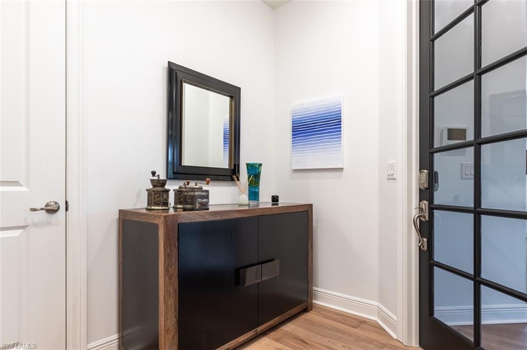 16360 Viansa Way, Unit 8201 Naples, FL 34110 - Photo 31 of 35 a bathroom with a sink and a mirror