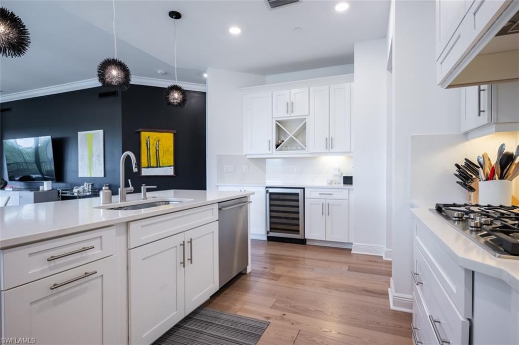 16360 Viansa Way, Unit 8201 Naples, FL 34110 - Photo 5 of 35 a spacious kitchen with stainless steel appliances a stove and a sink