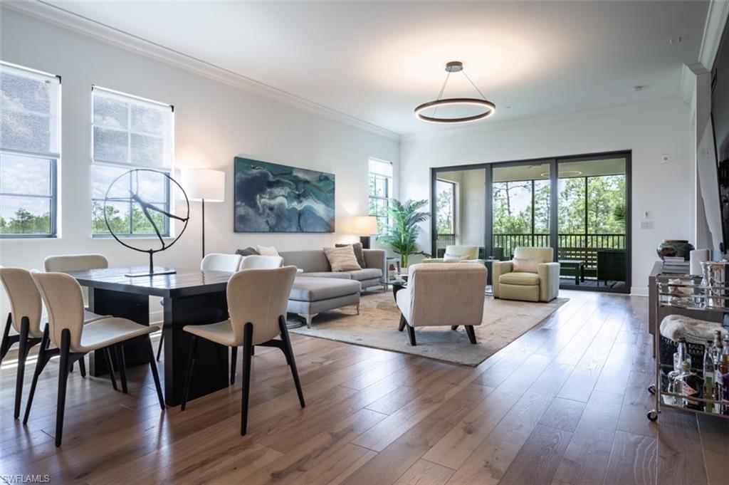 16360 Viansa Way, Unit 8201 Naples, FL 34110 - Photo 7 of 35 a living room with furniture and a wooden floor