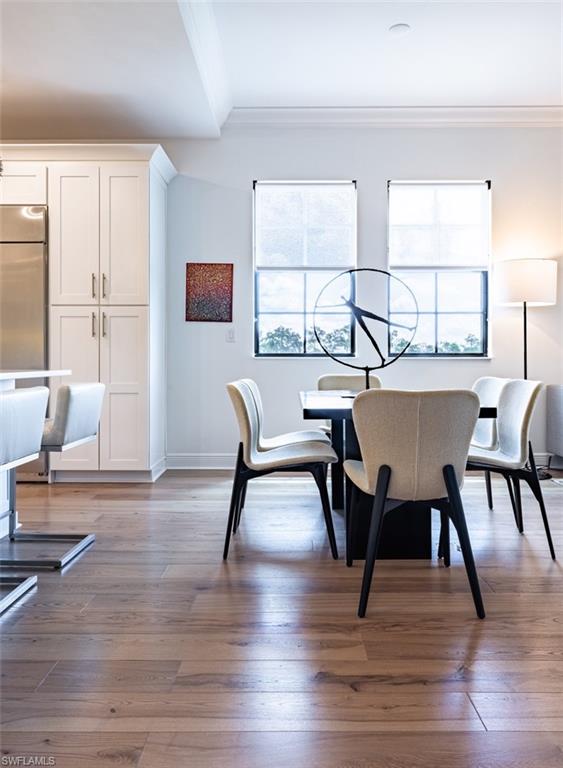 16360 Viansa Way, Unit 8201 Naples, FL 34110 - Photo 8 of 35 a view of a dining room with furniture and wooden floor