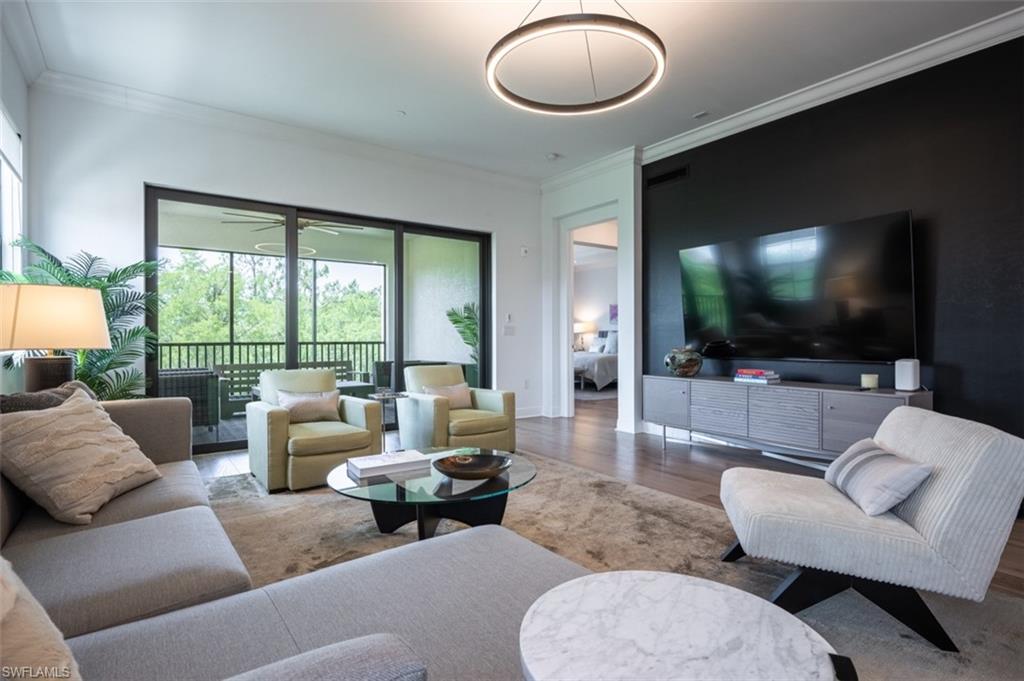 16360 Viansa Way, Unit 8201 Naples, FL 34110 - Photo 10 of 35 a living room with furniture and a flat screen tv