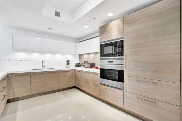 a living room with furniture kitchen view and a fireplace