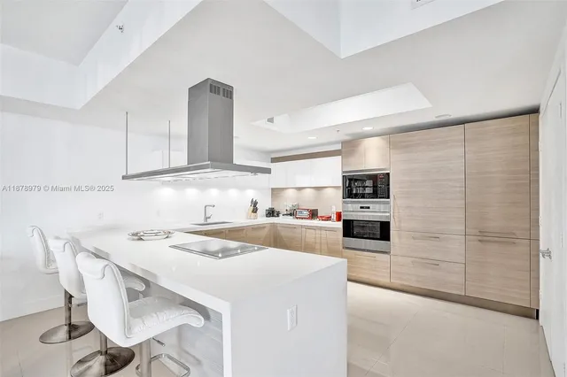a kitchen with a table chairs refrigerator and cabinets