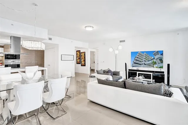 a living room with furniture tv and a floor to ceiling window
