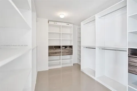 a bedroom with a bed and a cabinets