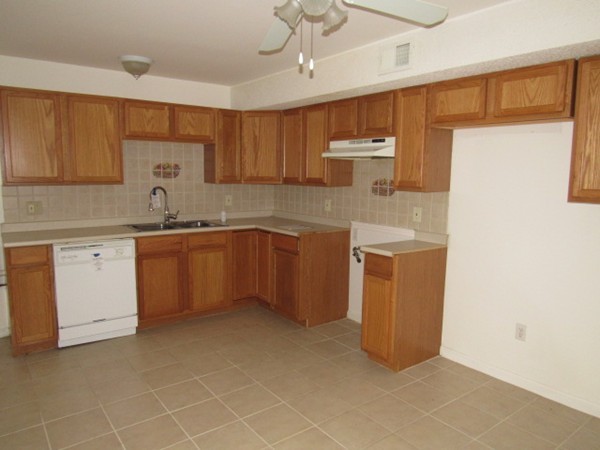 526 Third Street, Unit 4 Fall River, MA 02721 - Photo 2 of 11 a kitchen with a sink window and cabinets