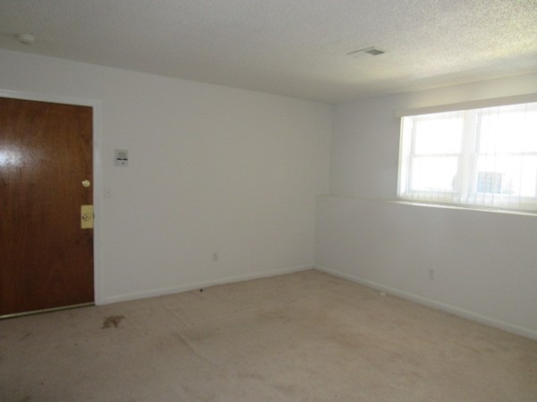 526 Third Street, Unit 4 Fall River, MA 02721 - Photo 4 of 11 an empty room with a window