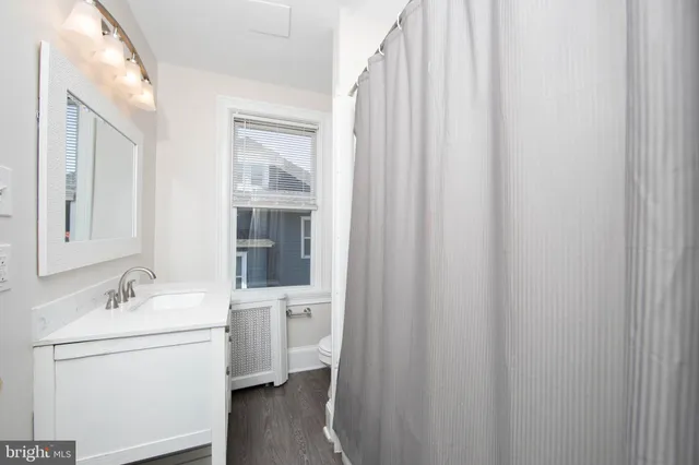 a bathroom with a sink a mirror and a shower