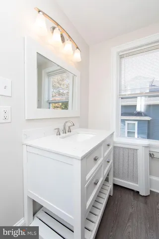 a bathroom with a double vanity sink and a window