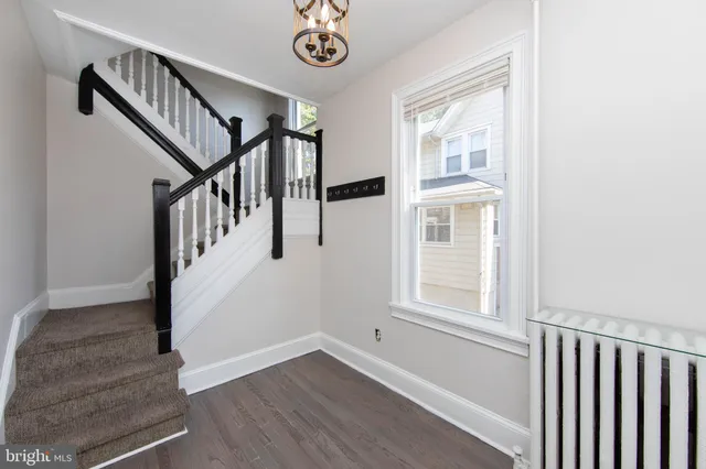 a view of an entryway with wooden floor