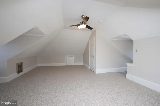 a view of empty room with ceiling fan