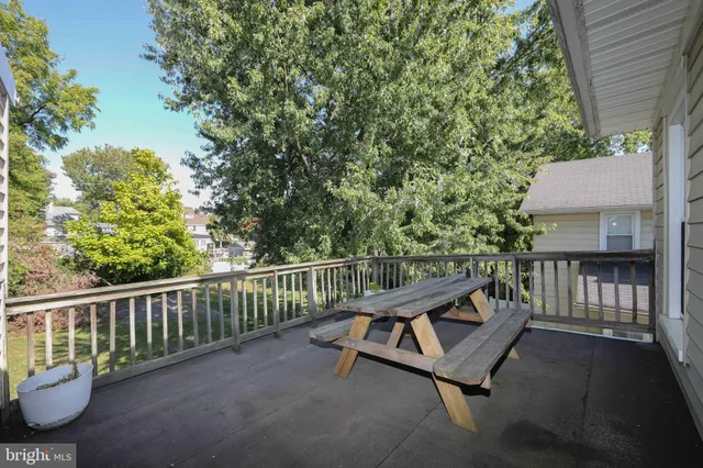 a view of backyard with deck and a garden