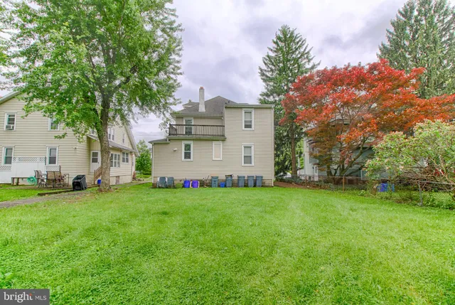 a view of a backyard with large trees