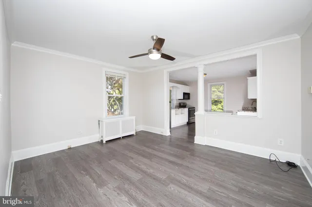 wooden floor in an empty room with a window