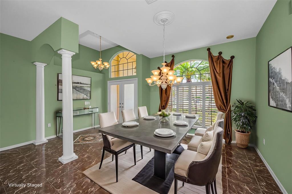 11917 Hadleigh Way Trinity, FL 34655 - Photo 9 of 84 a view of a dining room with furniture and a chandelier