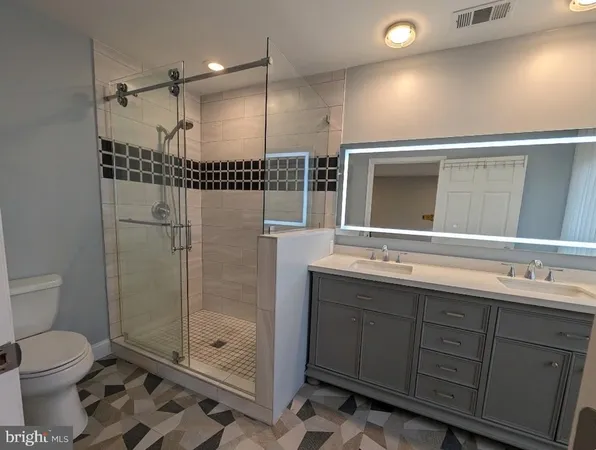 a bathroom with a toilet a sink and shower