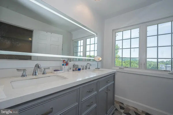 a bathroom with a sink and a window