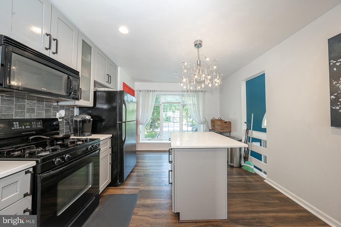 39 Cabot Drive Chesterbrook, PA 19087 - Photo 6 of 25 a kitchen with stainless steel appliances a chandelier open stove top oven and cabinets