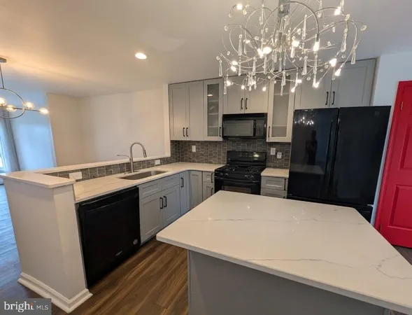 a kitchen with stainless steel appliances a refrigerator sink and microwave