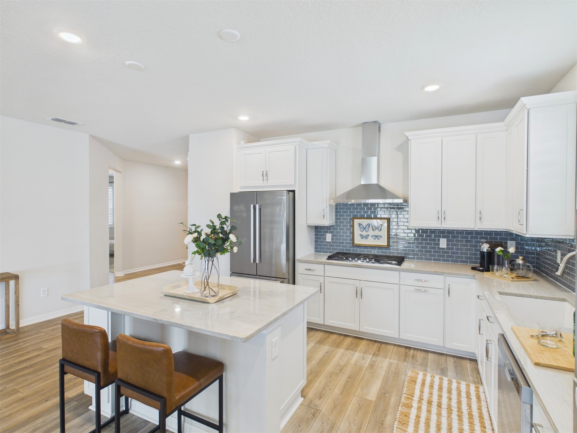 312 Salt Meadow Loop Yulee, FL 32097 - Photo 8 of 22 a kitchen with stainless steel appliances a sink a stove a refrigerator cabinets and dining table