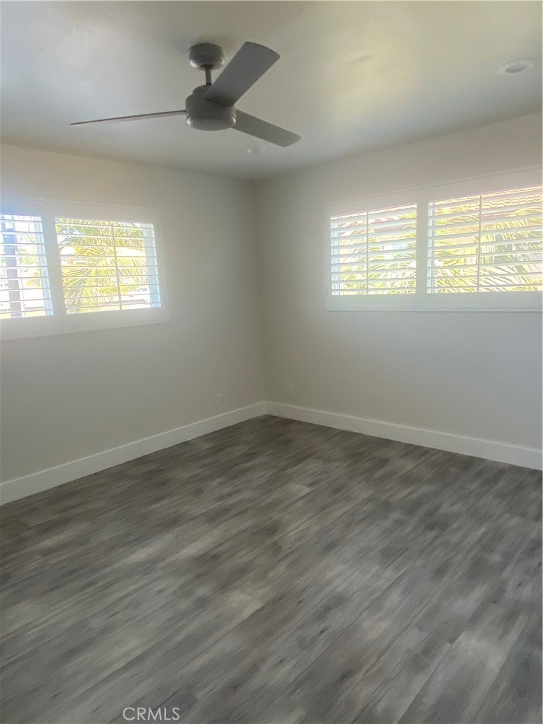 26891 Vista Del Mar, Unit A Dana Point, CA 92624 - Photo 13 of 25 an empty room with wooden floor and windows