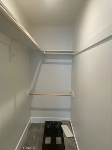 a view of walk in closet with empty racks