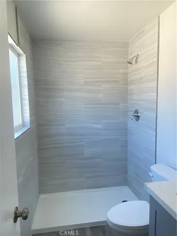 a bathroom with a shower and a toilet