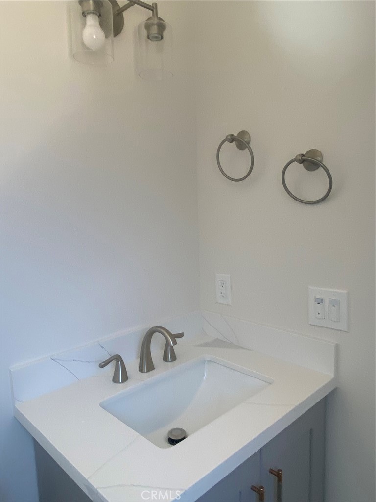 26891 Vista Del Mar, Unit A Dana Point, CA 92624 - Photo 18 of 25 a bathroom with a sink and mirror