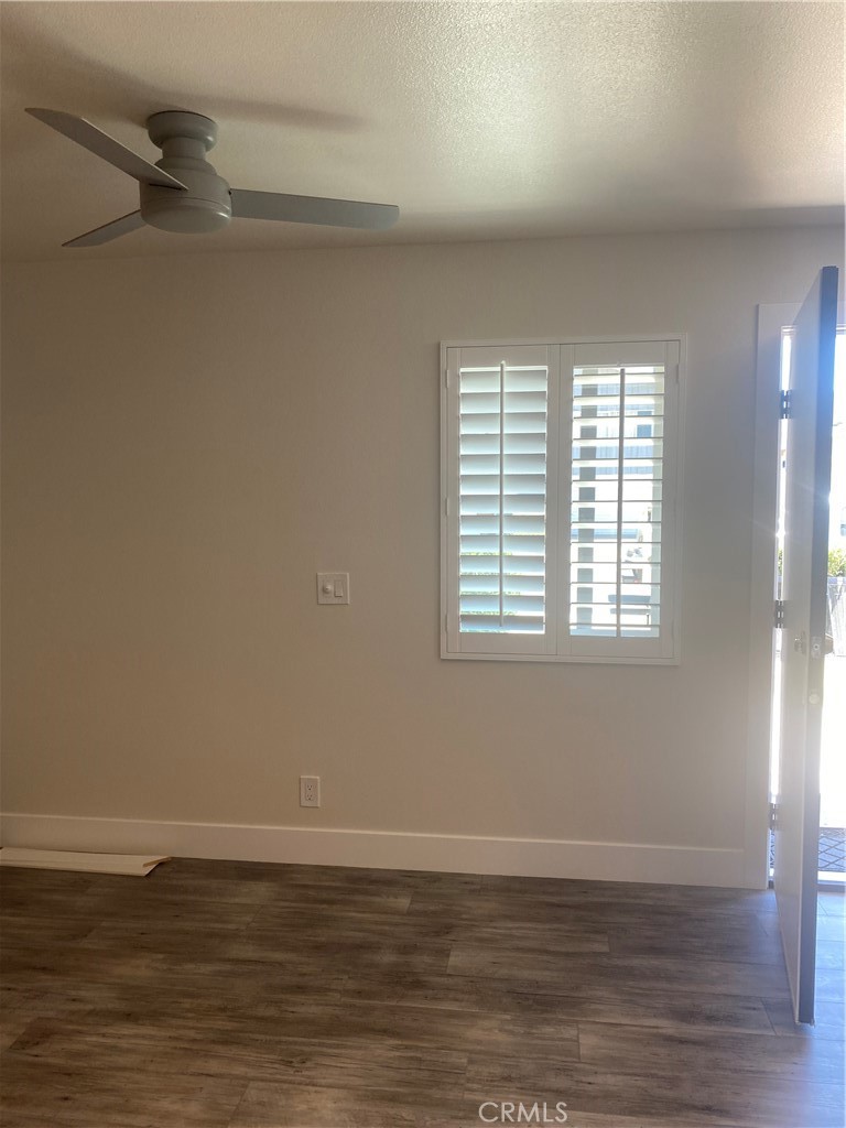 26891 Vista Del Mar, Unit A Dana Point, CA 92624 - Photo 20 of 25 a view of an empty room with wooden floor and a window