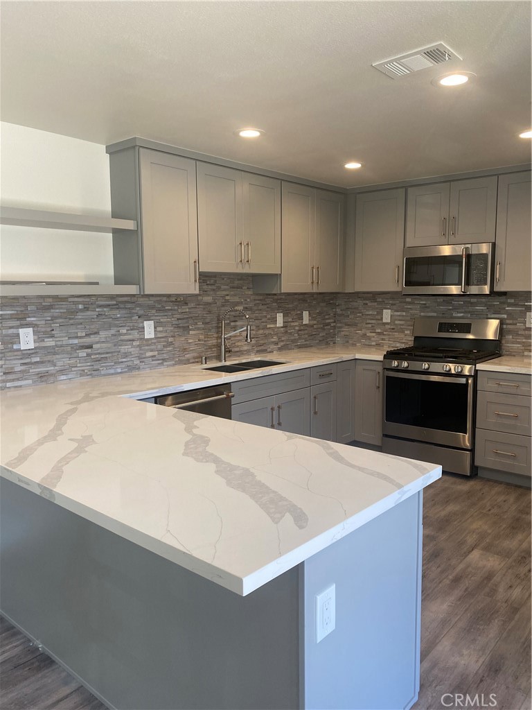 26891 Vista Del Mar, Unit A Dana Point, CA 92624 - Photo 21 of 25 a kitchen with stainless steel appliances a sink a stove top oven a counter top space and cabinets