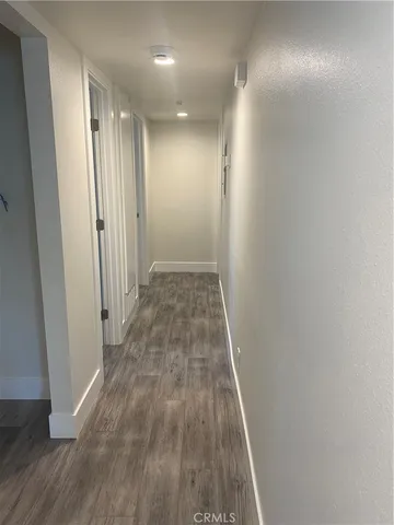 a view of hallway with wooden floor