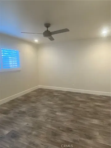 en empty room with window and ceiling fan