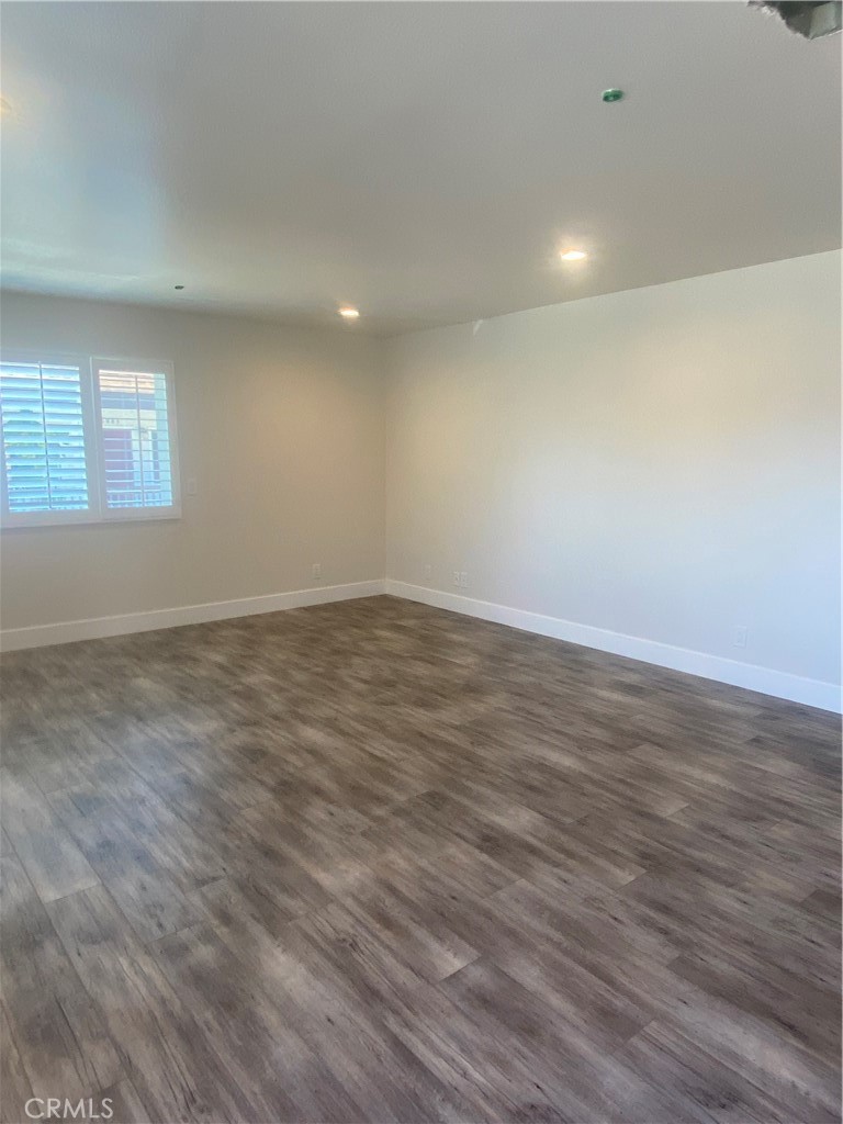 26891 Vista Del Mar, Unit A Dana Point, CA 92624 - Photo 7 of 25 an empty room with wooden floor and windows