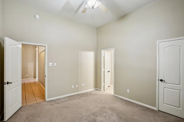 an empty room with a ceiling fan