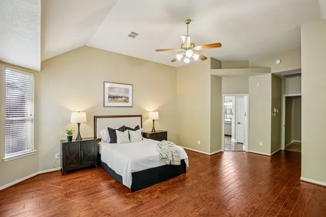 a bedroom with a bed and wooden floor