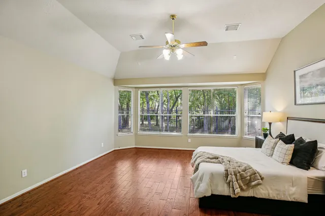 a spacious bathroom with a tub sink and mirror