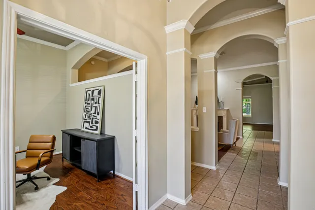 a view of a hallway with bathroom and a mirror