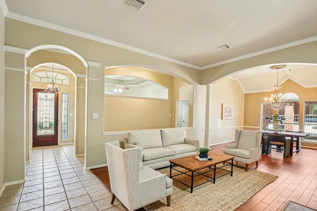 a living room with fireplace furniture and a table