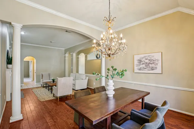 a view of a dining room with furniture and chandelier
