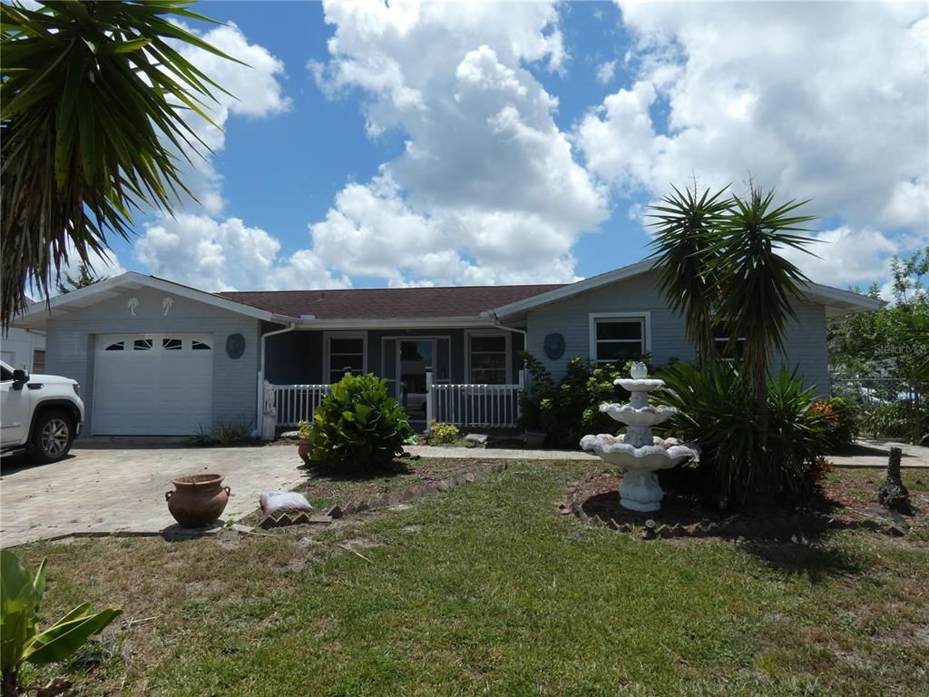 7514 Spirea Drive Port Richey, FL 34668 - Photo 1 of 1 a house view with a garden space