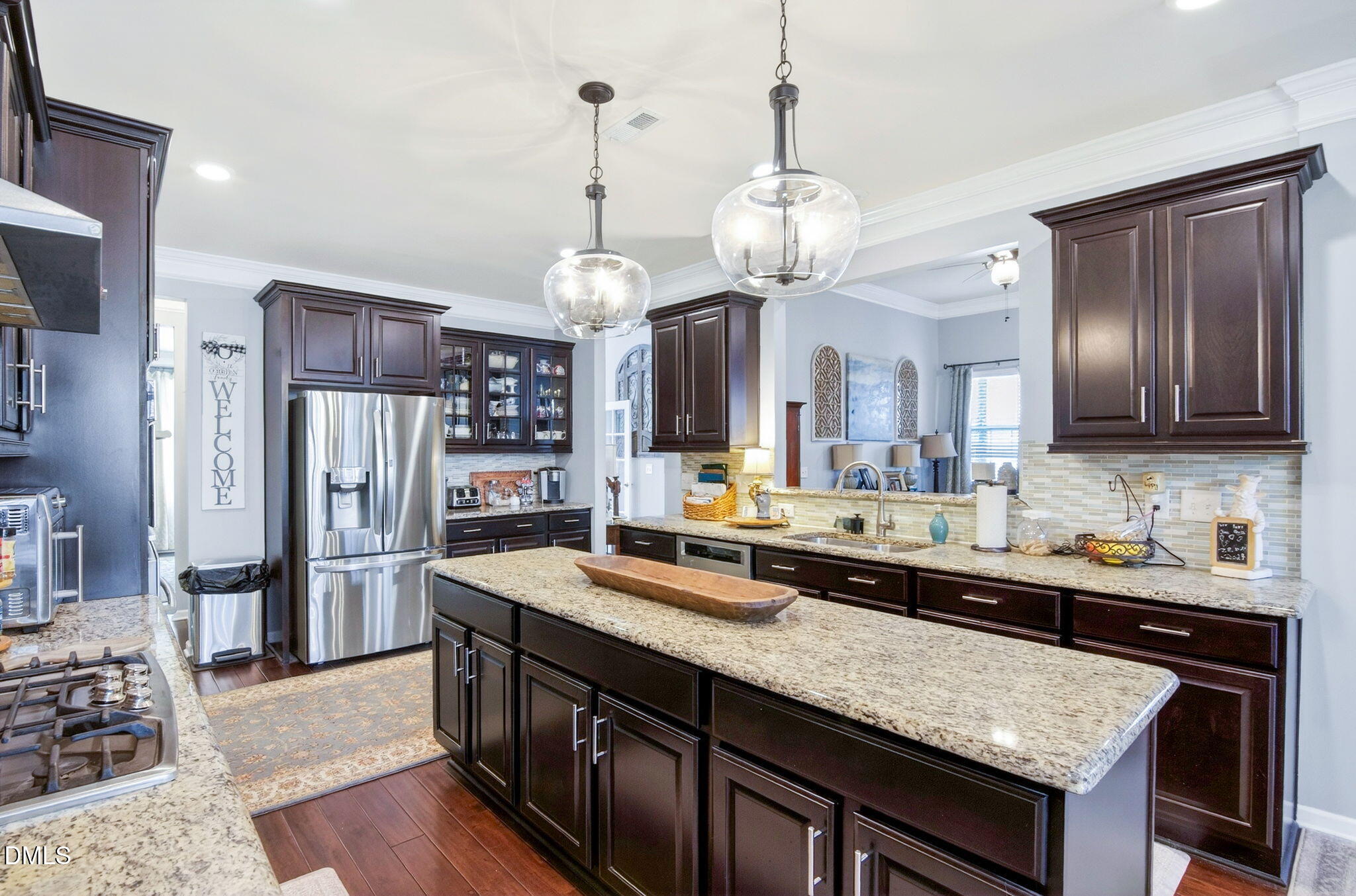 307 Marbella Drive Rolesville, NC 27571 - Photo 28 of 65 a kitchen with stainless steel appliances granite countertop stove a refrigerator and a sink with wooden floor