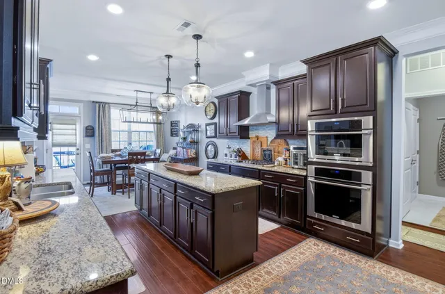 a bedroom with a bed and dresser with mirror
