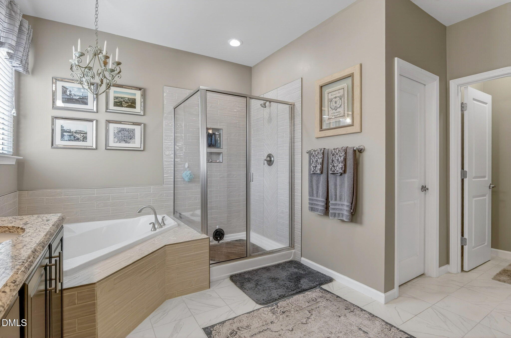 307 Marbella Drive Rolesville, NC 27571 - Photo 38 of 65 a spacious bathroom with a tub shower and mirror