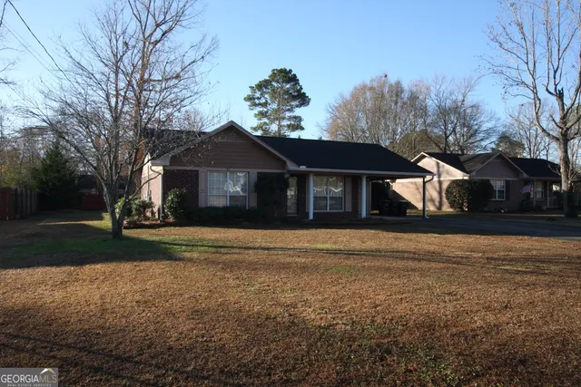 a front view of a house with a yard